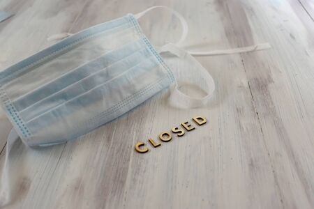 Front view of surgical mask over rustic background with copy spaceの写真素材