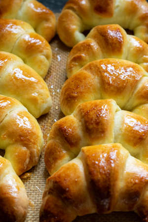 Argentine croissants, medialunas de Manteca over silicon pastry mat. Verticalの写真素材