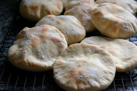 Pita Bread, focaccias, ciabatta with flour coat over cooling ragの写真素材