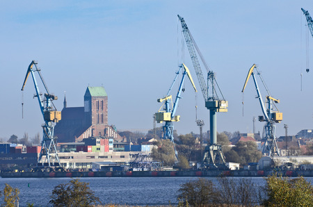 Industrial crane at the port with church from wismar in the backgroundのeditorial素材