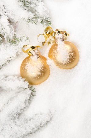 golden christmas balls in the snowの写真素材