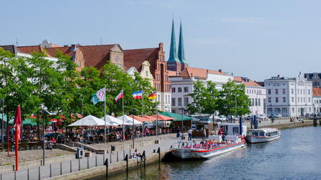 Luebeck, Germany-22 June 2017, view of the Upper Trave Street with street cafes on a beautiful summer dayのeditorial素材
