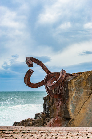 Sculpture The Comb of the winds in San Sebastian , Spain during stormy weather with scenic waves crushing upon stonesのeditorial素材
