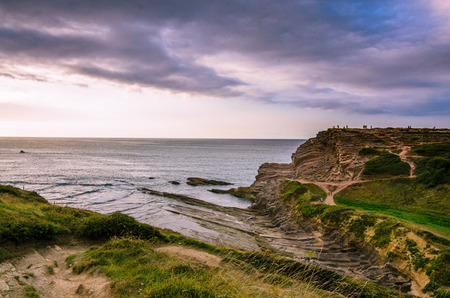 A view of red rocks of Zumaia Flych, Basuqe country Spain at a sunsetの写真素材