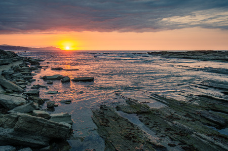 Dramatic golden sunset at Zumaia Flych, Basque country, Spainの写真素材