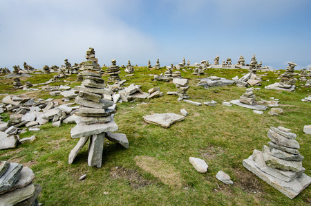 Stack of balancing stones on the top of a mountain in French Pyrenees with a view to downhills.の写真素材