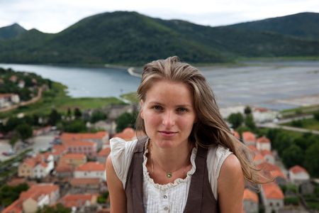 Young female on background of agricultural landscapeの写真素材