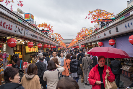TOKYO, JAPAN - November 10, 2015 : Tourists shop souvenir street at Senso-ji Temple. Senso-ji Buddhist Temple is the symbol of Asakusa and it is the most famous temples of Japan.のeditorial素材