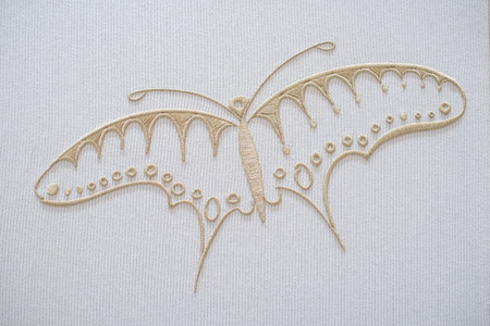 Embroidery butterfly on cotton backgroundの写真素材