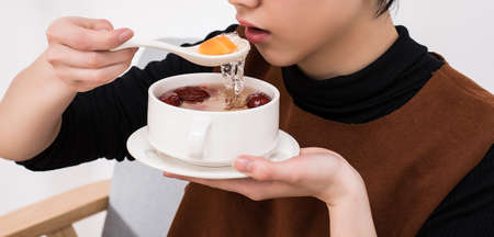 The lady is eating snow swallowsの写真素材