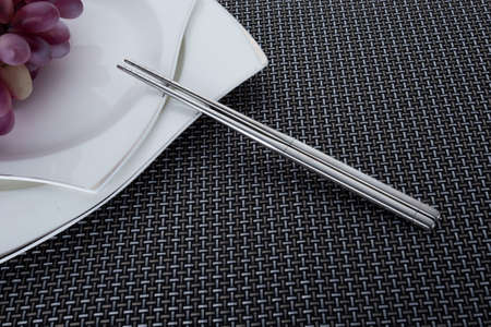 Stainless steel cutlery and kitchenware on the tableの写真素材