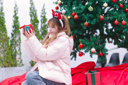 beautiful girl holding a gift during the festivalの写真素材