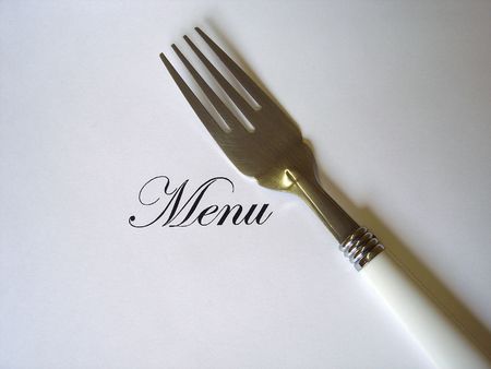Close up view of the word Menu written and a fork all on a white background with free space to write what you wantの写真素材