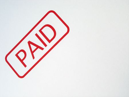 Close up view of a PAID stamp impression               の写真素材