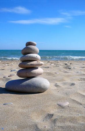 close up view of six zen stones in a beachの写真素材