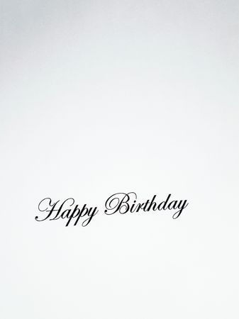 Close up view of the words Happy Birthday written in a classic type on a white backgroundの写真素材
