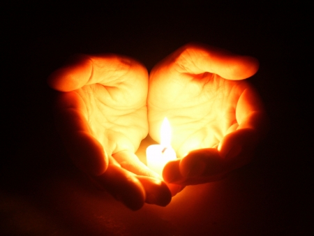 Hands holding a candleの写真素材