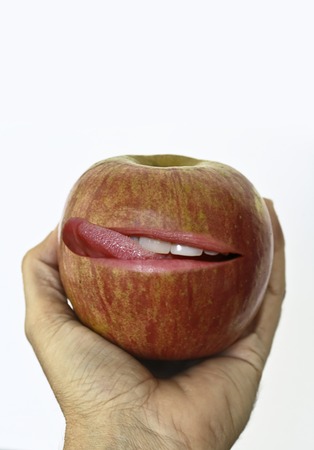 Hand holding an Apple Smacking lips