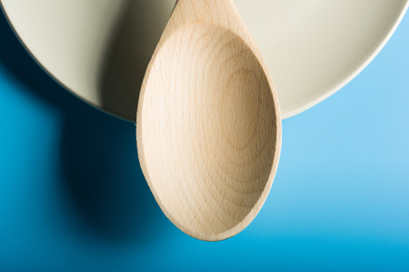 Empty Wood Spoon in blue backgroundの写真素材