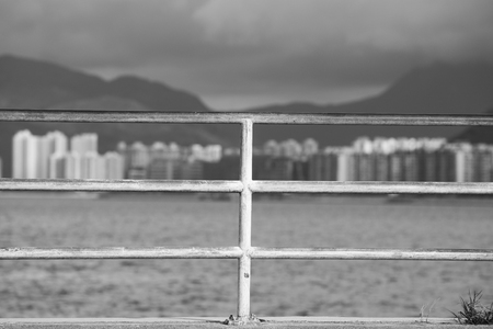 Monochrome: Hand railing near seaの写真素材