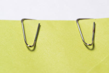 Two paper clips and green envelopeの写真素材