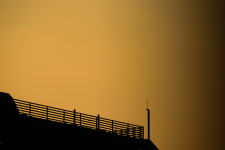 Handrail on the top of the building with sunset backgroundの写真素材
