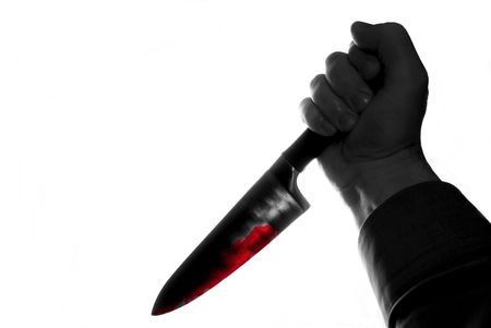 black and white hand with knife stained with bloodの写真素材