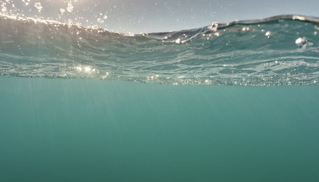 Underwater view of a wave with sunbeams and copy spaceの素材