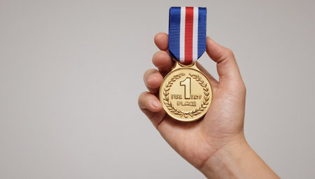 Bronze medal in hand isolated on white background with copy space.の素材