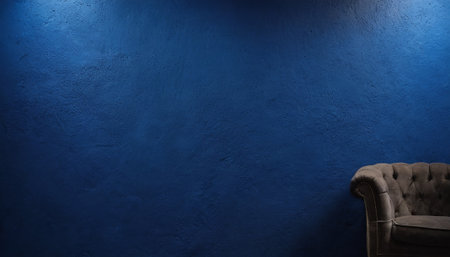 Luxury leather armchair against a blue wall with copy spaceの素材