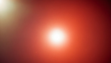 Red background with lens flare. Abstract red background with lens flare.の素材