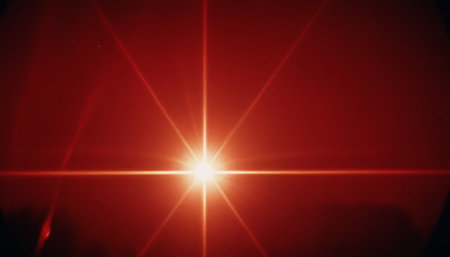 Abstract red background with sun rays and lens flare. Sunbeams.の素材