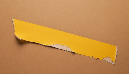 Torn paper with space for your message on a brown background.の素材