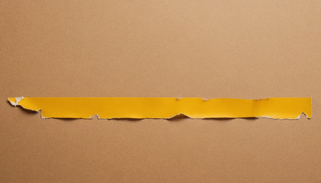 Torn paper with space for your message on a brown background.の素材