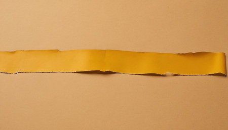 Torn paper with space for your message on a brown background.の素材