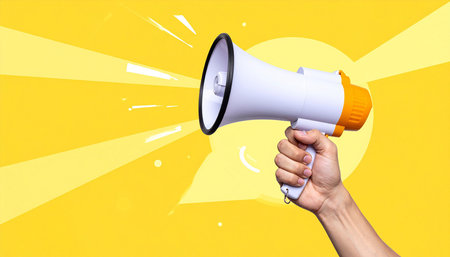 Close up of human hand holding megaphone with colorful speech bubbleの素材