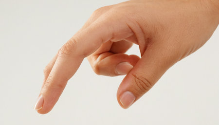 Female hand on a white background. Isolated. Close up.の素材