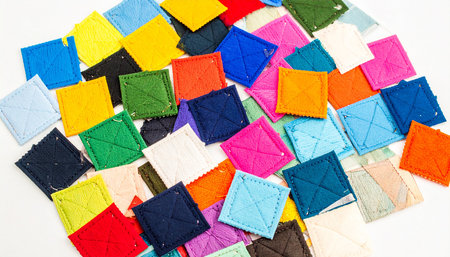 Colorful fabric patchwork on white background, close up view.の素材