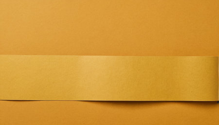 close up of yellow paper ribbon on orange background, empty space for textの素材