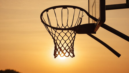 Basketball hoop silhouette at sunset, close-up. Sport backgroundの素材