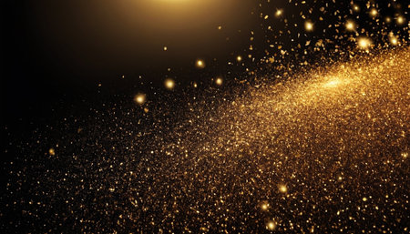 Golden glittering particles on a black background. Golden glittering particles.の素材