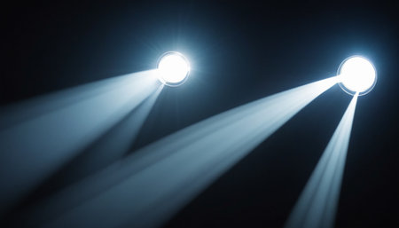 stage lighting effect on a dark background with rays of light and smokeの素材