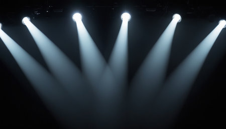 Stage lights on a black background. The stage is illuminated by spotlights.の素材