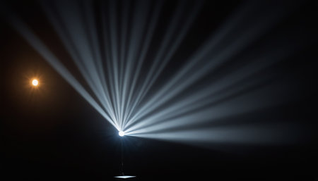 Spotlight on the stage in a dark room with lighting effects.の素材
