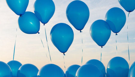 Blue balloons on blue sky background. Colorful balloons in the sky.の素材