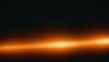 Abstract dark background with orange gradient and glow. Copy space for text.の素材