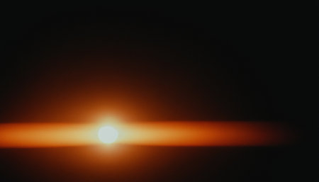sunset with lens flare over black background. abstract photo illustration.の素材