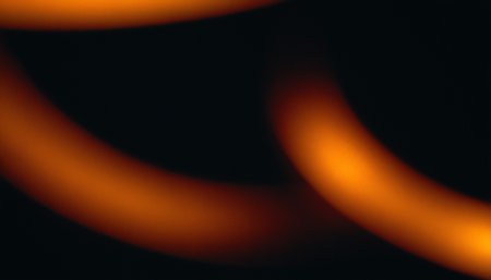 abstract orange and black background with bokeh defocused lightsの素材