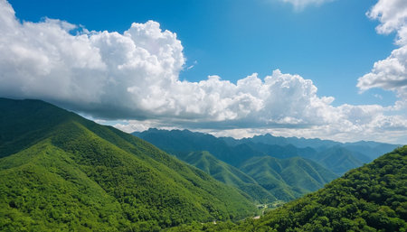Beautiful landscape of green mountains under blue sky and white clouds.の素材