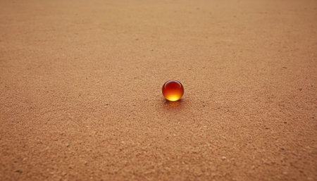 Glass ball on the ground. Selective focus. Toned.の素材